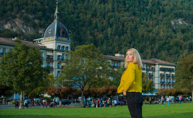 Vacation in Switzerland - Interlaken. Concept of tourism and holidays. Woman in city streets, urban scene