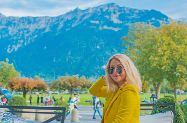 Vacation in Switzerland - Interlaken. Concept of tourism and holidays. Woman in city streets, urban...