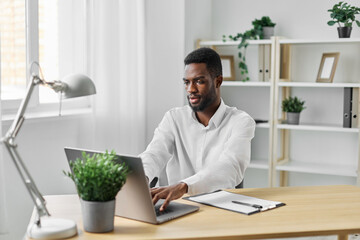 man american indoor computer laptop job student education african freelancer online office