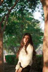 Autumn portrait of an attractive young woman in stylish glasses in a knitted fashionable white...