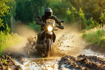 Deurstickers Motocross rider in action on a muddy road at sunset. Motocross. Enduro. Extreme sport concept. © John Martin