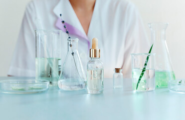 Woman examining green plant in laboratory