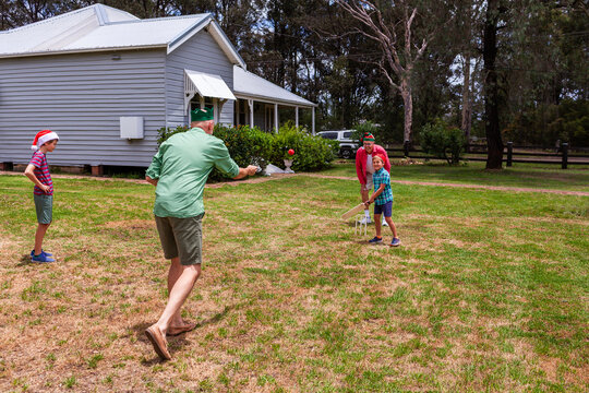 Christmastime family fun backyard cricket game - Powered by Adobe