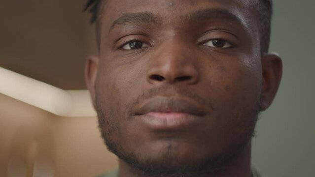 30-year-old black man beams with a radiant smile looking at camera. A celebration of happiness and positive energy
