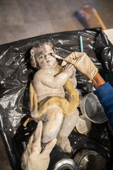 Visible Restoration Process on Angle Sculpture Face from a Church Altair Where We can See the Clened part Versus the Still to Work on Part of its Face