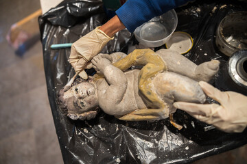 Visible Restoration Process on Angle Sculpture Face from a Church Altair Where We can See the Clened part Versus the Still to Work on Part of its Face