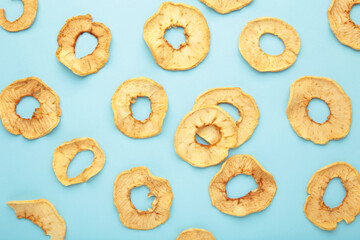 Dried apples on a blue background. Flat lay