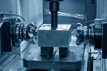 The duplex CNC milling machine cutting the metal parts in the light blue scene. The high technology...