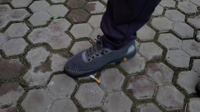 Man destroying cigarette  by its shoes, No smoking concept