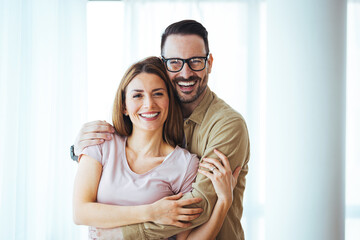 Portrait of smiling couple thinking about the future. Happy cheerful couple relaxing at home....