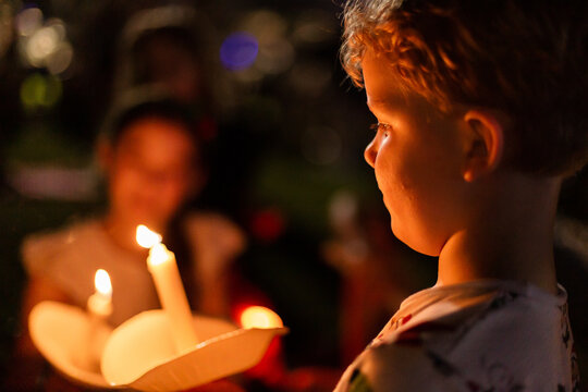 boy holding a real candle at carols by candlelight