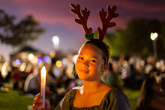 teen girl smiling at the camera at carols by candlelight