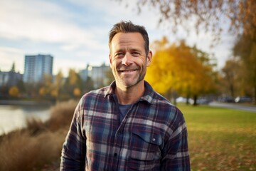 Portrait of a blissful man in his 40s wearing a comfy flannel shirt against a vibrant city park. AI Generation