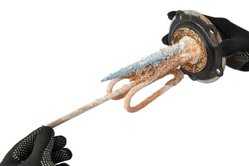 hand of a craftsman dismantled the old heating element of an electric hot water boiler with scale...