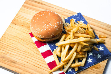 Cheese burger - American cheese burger with Golden French fries on wooden board