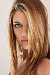 Naklejka premium Woman, portrait and makeup beauty with confidence for cosmetic style for wellness glow, shine or health. Female person, face and model at studio background for self care pride, hair or grooming