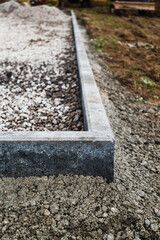 Concrete garden borders with cement to demarcate paths, parkings, sidewalks and flowerbeds