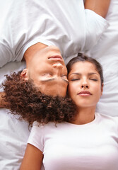 Obraz na płótnie Canvas Sleeping, duvet and face of couple in bedroom for comfort, cozy nap and rest with eyes closed in Puerto Rico home. Bed, fatigue and top view of man, woman or people sleep with calm, peace or wellness