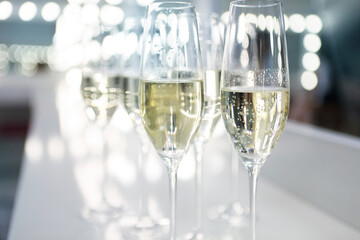 Champagne glasses on white background in bright lights