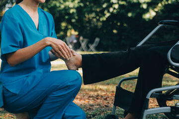 young asian physical therapist working with senior woman on walking with a walker