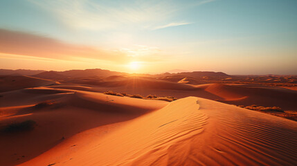 Fototapeta na wymiar A vast desert landscape at sunset with dunes and sparse vegetation.