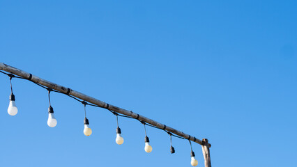shimmering lamps in series on a evening, blue sky with cloud