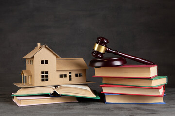 House model, gavel and books on the desk, Real property law concept, real estate auction - 716680650