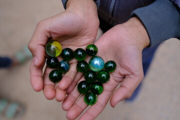 Closeup shot of beautiful marble balls in hands