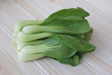 Fresh Bok Choy or Pak Choi or Chinese cabbage on wooden background for cooking. Concept, Organic vegetables. Healthy food. High fibers and vitamins. Food ingredients.        