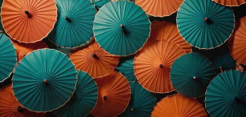  a bunch of orange and green umbrellas that are stacked on top of each other in the same pattern as a wall of orange and green umbrellas that are stacked on top of each other. - obrazy, fototapety, plakaty