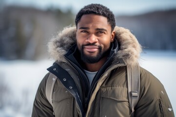 Portrait of a blissful afro-american man in his 30s wearing a rugged jean vest against a backdrop of a frozen winter lake. AI Generation