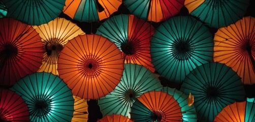  a group of multicolored umbrellas sitting next to each other on a black background with a green, red, orange, and blue umbrella in the middle.