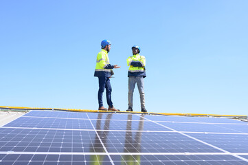 A team of engineers is laying out the installation of an outdoor solar panel system. Installing solar cells on the roof. Solar panels on the roof Workers install eco-technology photovoltaic power plan