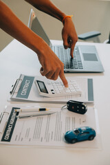 Closeup asian male people car salesman or sales manager offers to sell a car and explains and reads the terms of signing a car contract and insurance.