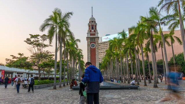 Time Lapse  Former railway clock tower. Kowloon-Canton At Tsim Sha Tsui tourist landmark in Hong Kong
