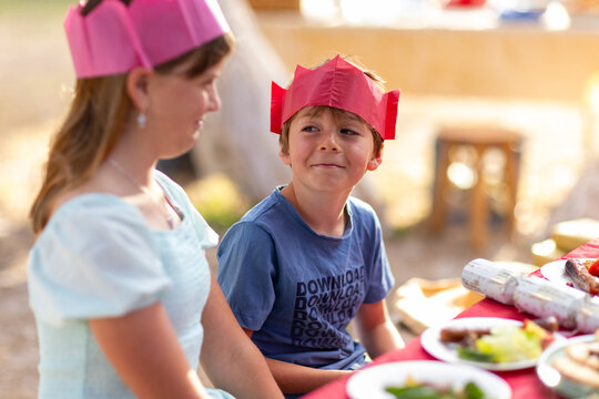 brother and sister at Christmas lunch table trying not to laugh