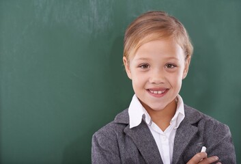 Child, portrait and chalkboard for school education in classroom for learning, writing or homework. Female person, uniform and kindergarten development or brainstorming or knowledge, study or mockup