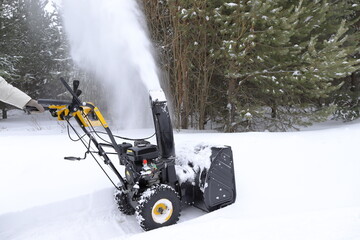 Removal the path and the territory of the courtyard of the house from snow  with the help of a snow...
