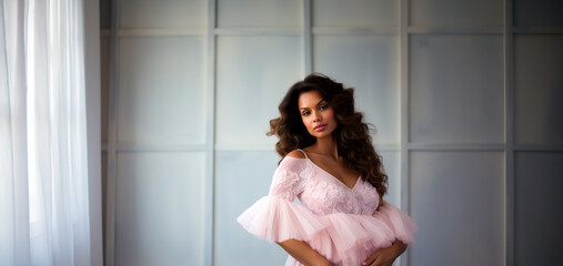 Beautiful african american woman in pink dress, indoor photo