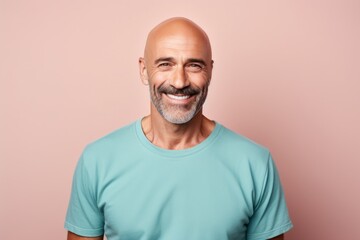 Obraz premium Portrait of a cheerful man in his 40s donning a trendy cropped top against a pastel gray background. AI Generation