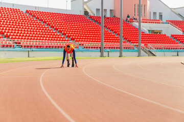 Asian para-athlete runner prosthetic leg on the track alone outside on a stadium track Paralympic running concept.