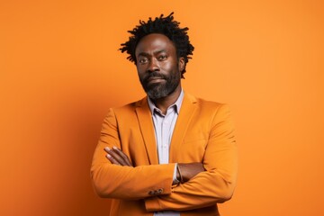 Portrait of a blissful afro-american man in his 40s dressed in a stylish blazer against a soft orange background. AI Generation