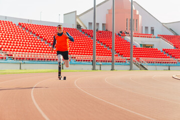 Asian para-athlete runner prosthetic leg on the track alone outside on a stadium track Paralympic...