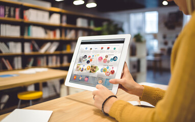 Digital tablet in the hands of a woman with a blank screen of a mobile application