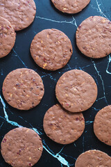 Homemade chocolate shortbread with fruits and nuts on marble background
