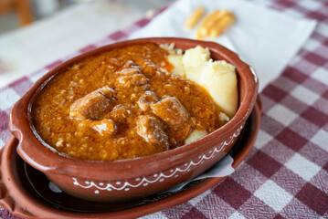 Goulash", (Hungarian: gulyás)
a soup or stew of meat and vegetables seasoned with paprika and other spices, a common meal eaten mainly in Central Europe. Served with mashed potatoes. 