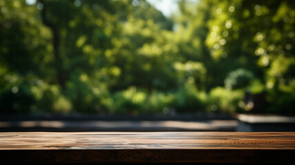 The empty wooden table top with a garden blurred background