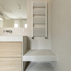 Modern design bathroom with cream marble sink on wooden cabinet with drawers