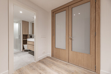Fototapeta na wymiar A small bathroom with modern design wooden hanging furniture