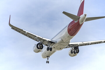 View of the rear fuselage of a passenger plane with landing gear deployed